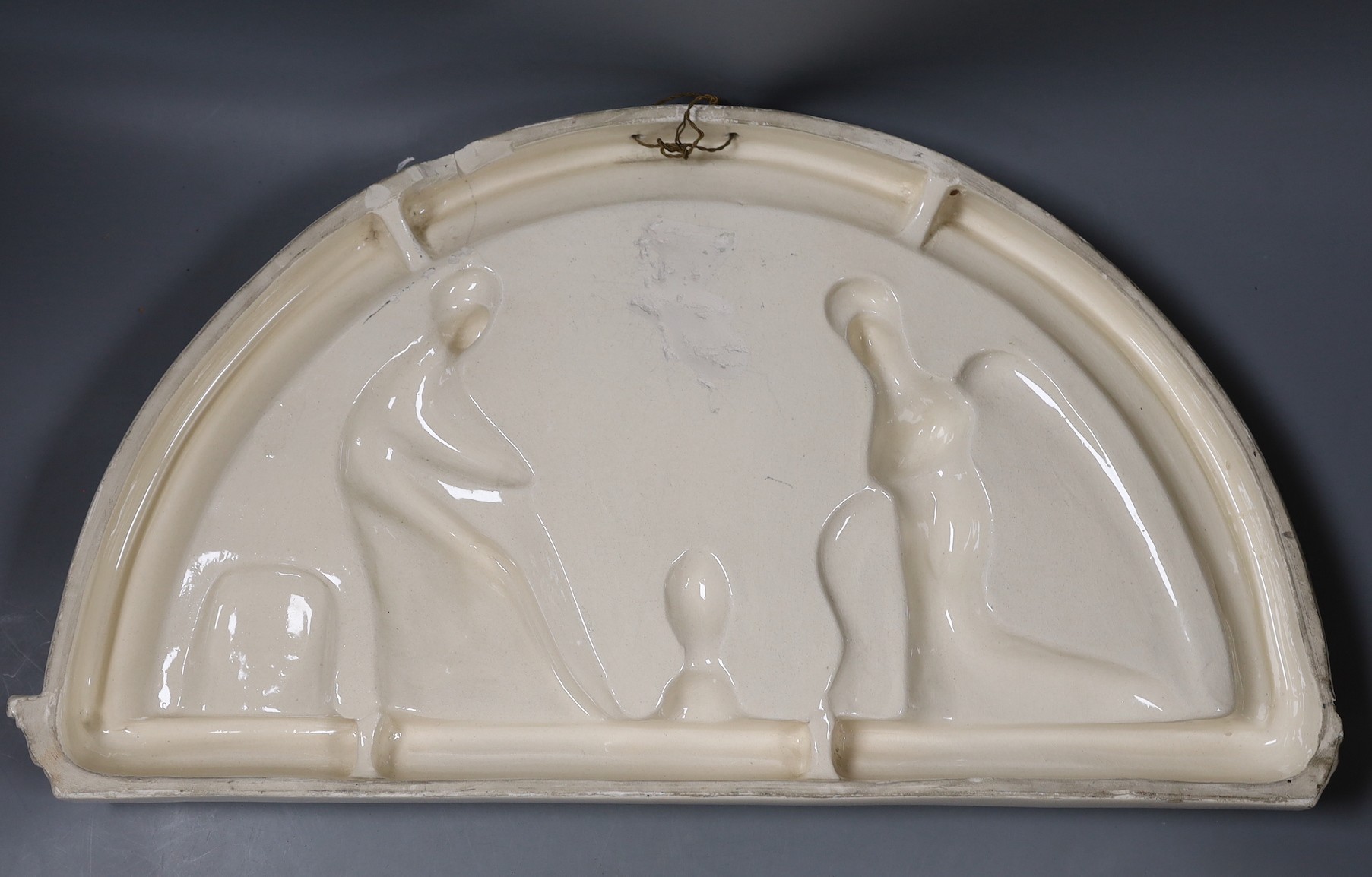 A Della Robbia style ceramic door pediment, 57.5cm wide